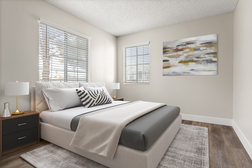 a bedroom with a bed and two windows